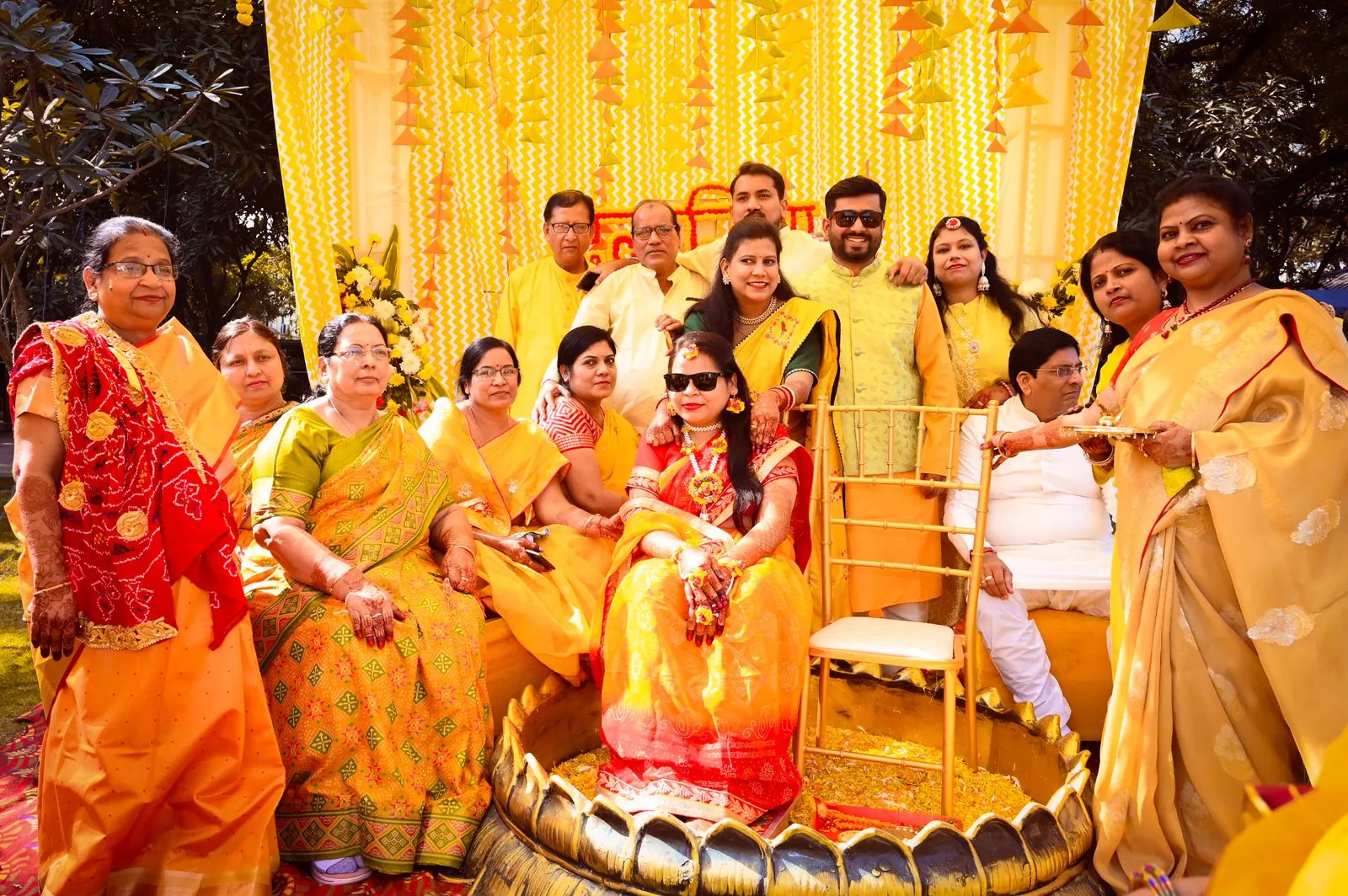 Family members in yellow celebrating a haldi ceremony